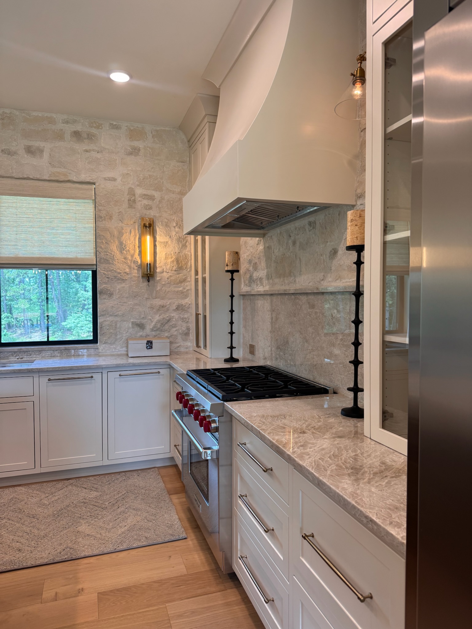 The Market Project kitchen with white cabinetry and natural stone